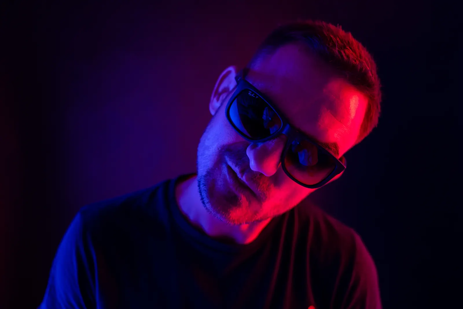 Special D. in sunglasses under neon light